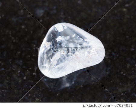 tumbled rock crystal gemstone on dark background tumbled rock crystal gemstone on dark background 37024031