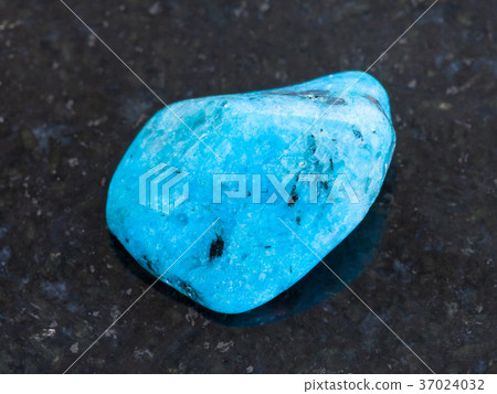 polished blue Agate gemstone on dark background polished blue Agate gemstone on dark background 37024032