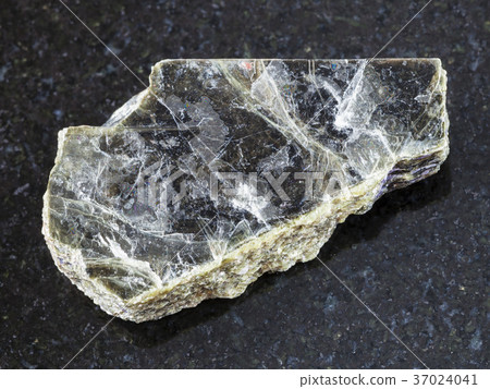 raw muscovite mica stone on dark background raw muscovite mica stone on dark background 37024041