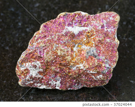 rough red Chalcopyrite stone on dark background 37024044