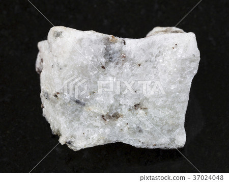 rough carbonatite stone on dark background 37024048