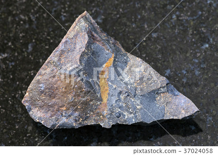 rough tagamite stone on dark background 37024058