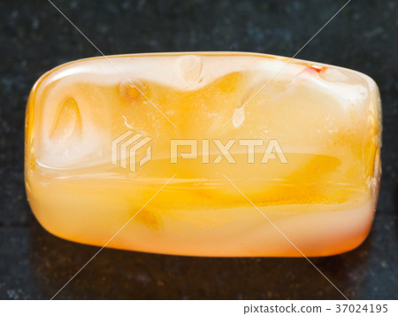 bead from yellow Agate gemstone on dark 37024195