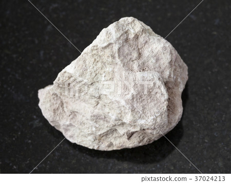 raw marl stone on dark background 37024213