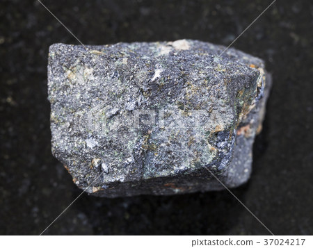 raw Molybdenite stone on dark background 37024217
