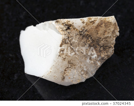 raw cacholong (white opal) stone on dark 37024345