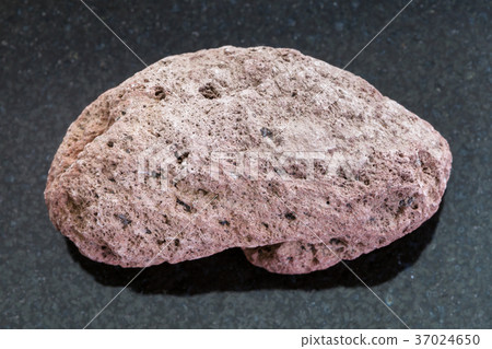 red pumice pebble on dark background 37024650