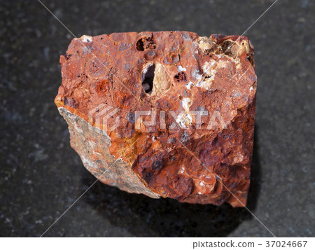 raw red bauxite stone on dark background 37024667
