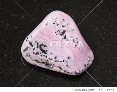 raw rhodochrosite gem on dark background 37024671