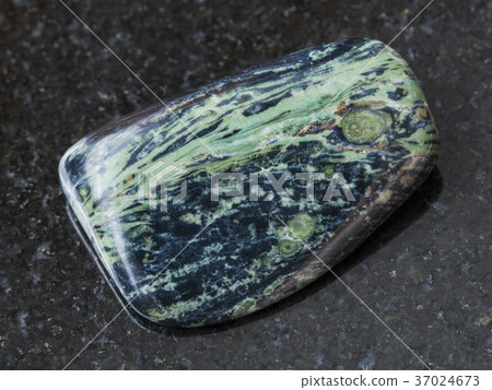 polished rhyolite gemstone on dark background 37024673