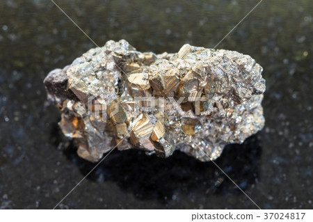 rough iron pyrite stone on dark background 37024817
