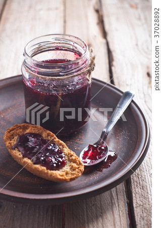 black currant jam in glass jar and crackers black currant jam in glass jar and crackers 37028892