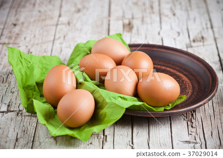 fresh brown eggs in plate and green napkin fresh brown eggs in plate and green napkin 37029014