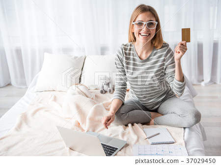 Happy woman making purchase by internet Happy woman making purchase by internet 37029450