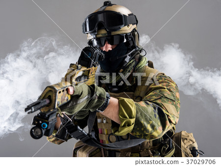 Man holding weapon in hands 37029706