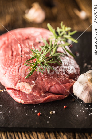 Flank steak with rosemary garlic salt and pepper. 37030461