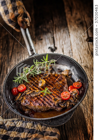 Grill beef flank steak with rosemary and musrooms. Grill beef flank steak with rosemary and musrooms. 37030463