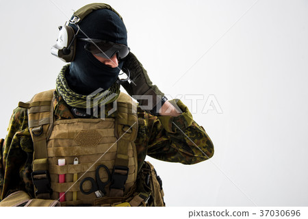 Serene soldier speaking by headset Serene soldier speaking by headset 37030696