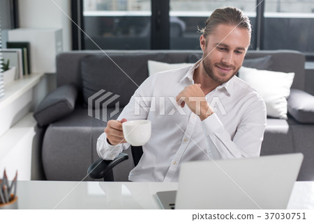 Tranquil businessman taking rest at work Tranquil businessman taking rest at work 37030751