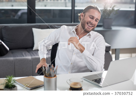 Joyful man having fun in the office Joyful man having fun in the office 37030752