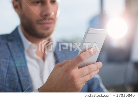 Bearded young male using gadget Bearded young male using gadget 37030840