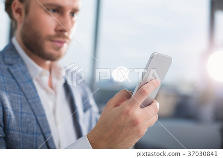 Relaxed manager typing on mobile phone Relaxed manager typing on mobile phone 37030841