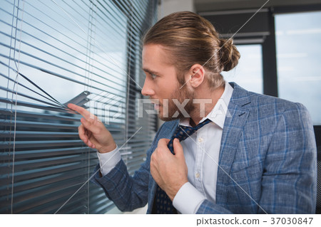 Curious manager supervising subordinates in the Curious manager supervising subordinates in the 37030847