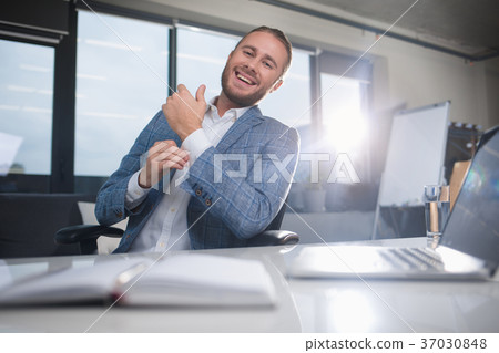 Smiling male buttoning on cuff Smiling male buttoning on cuff 37030848