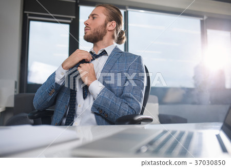 Calm employee freshening himself up Calm employee freshening himself up 37030850