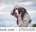 Photographer taking photo of landscape 37031020