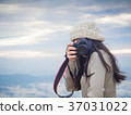 Photographer taking photo of landscape 37031022