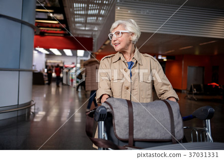 Old lady is waiting for boarding 37031331