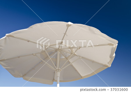 Beach umbrella against the blue clear sky 37031600