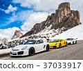 3 luxury sports cars, at the snow-covered Italian Alps at Giau Pass 37033917