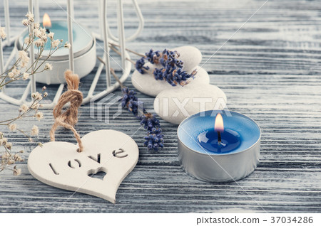Lavender flowers, blue lit candle and heart Lavender flowers, blue lit candle and heart 37034286
