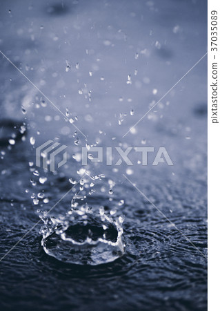 Rain drops on the surface of water. Rain drops on the surface of water. 37035089