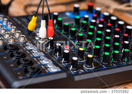 Close-up of DJ's audio mixing console 37035892