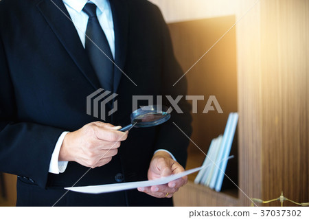 Judge lawyer read paper text by use Magnify glass Judge lawyer read paper text by use Magnify glass 37037302