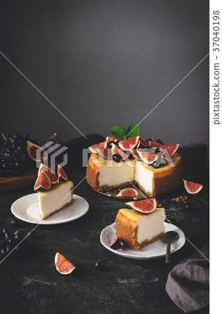 Sliced New York Cheesecake on dark stone 37040198