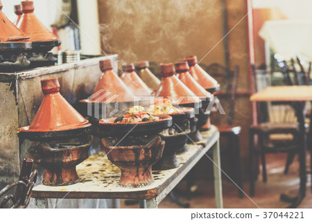 Cooking of meat in traditional Moroccan tajine Cooking of meat in traditional Moroccan tajine 37044221