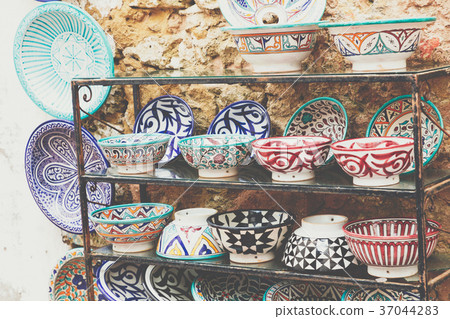 Plates, tajines and pots made of clay on the souk Plates, tajines and pots made of clay on the souk 37044283