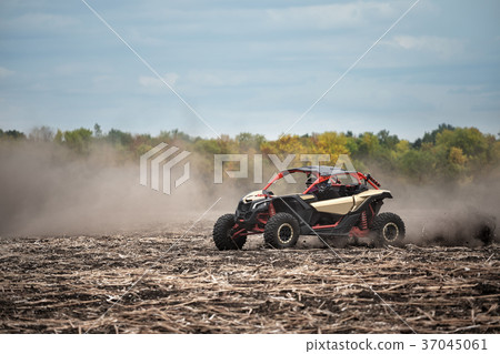 Quad bike in a plowed field Quad bike in a plowed field 37045061