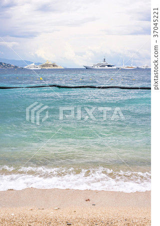 Daylight cloudy day view to beachline with ships 37045221