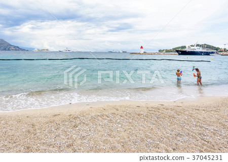 Daylight cloudy day view to beachline with ships 37045231