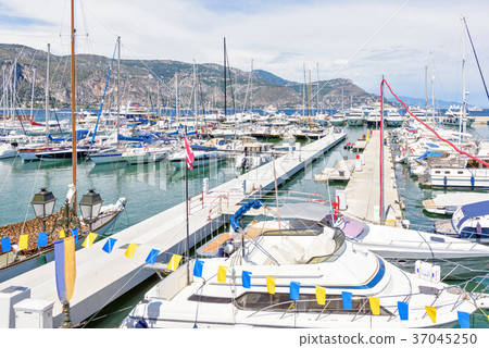Daylight sunny view to parked yachts in port 37045250
