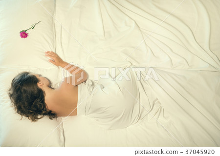 Beautiful naked female sleeping in bed.  37045920