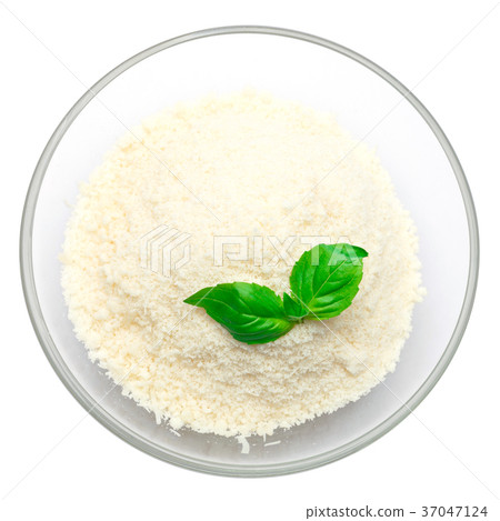 grated Parmesan cheese in glass bowl on white 37047124