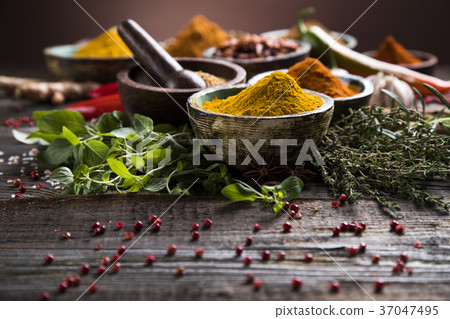 Spices on wooden bowl background 37047495
