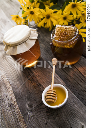 Fresh honey on wooden table Fresh honey on wooden table 37049094