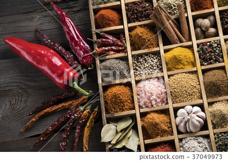 Herbs and spices on a wooden box board Herbs and spices on a wooden box board 37049973